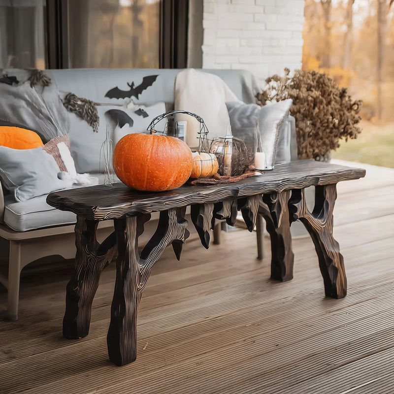 Live edge solid wood coffee table with carved legs, autumn decor and pumpkins on porch
