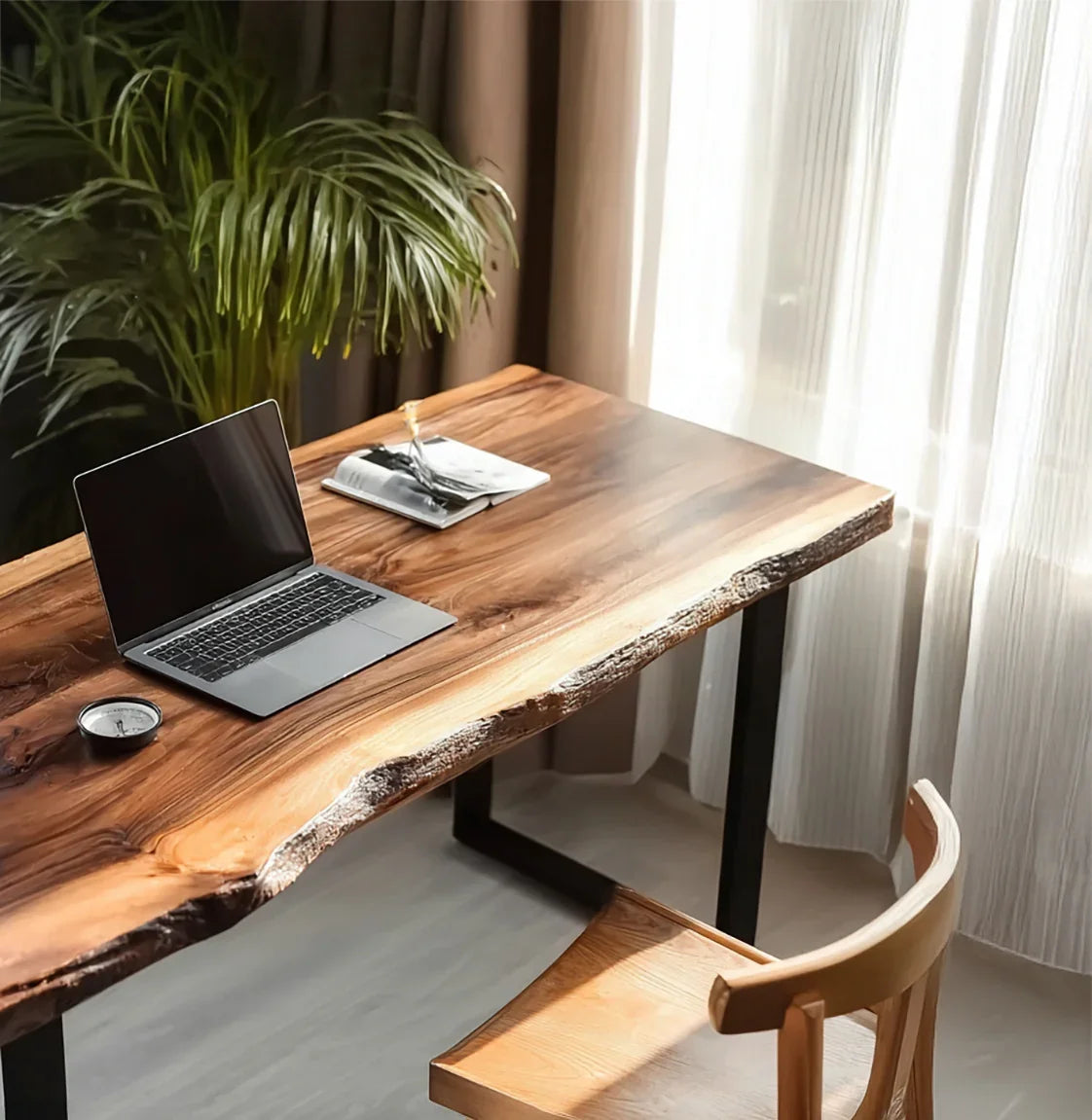 Wooden live edge desk with laptop, book, compass, wooden chair, and bright natural light