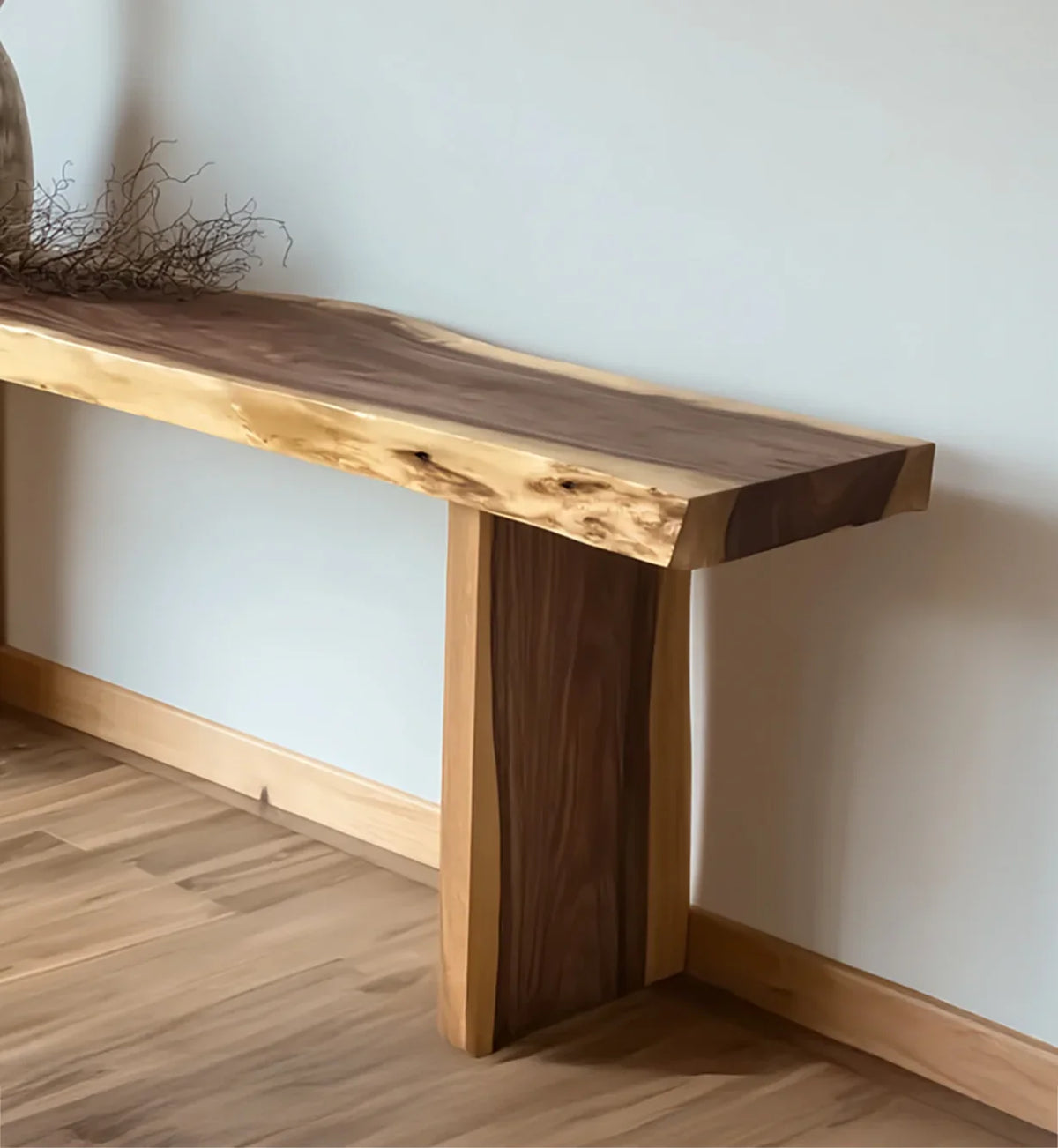 Live edge solid wood console table with natural finish against a light wall