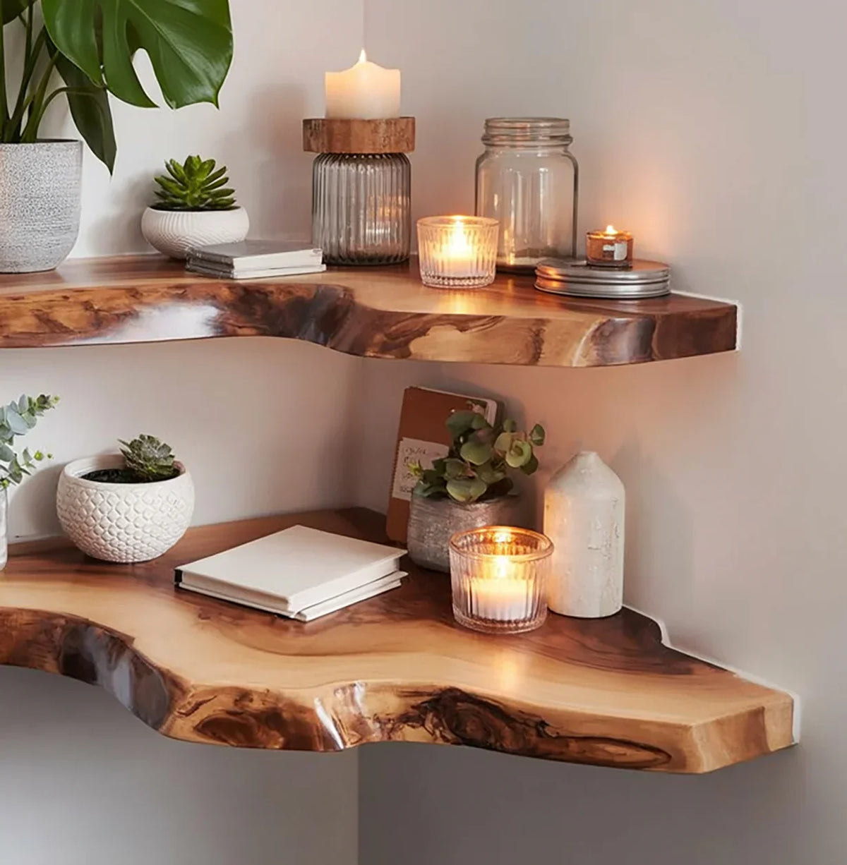 Live edge floating wooden shelves with candles, potted plants, and notebooks in cozy decor