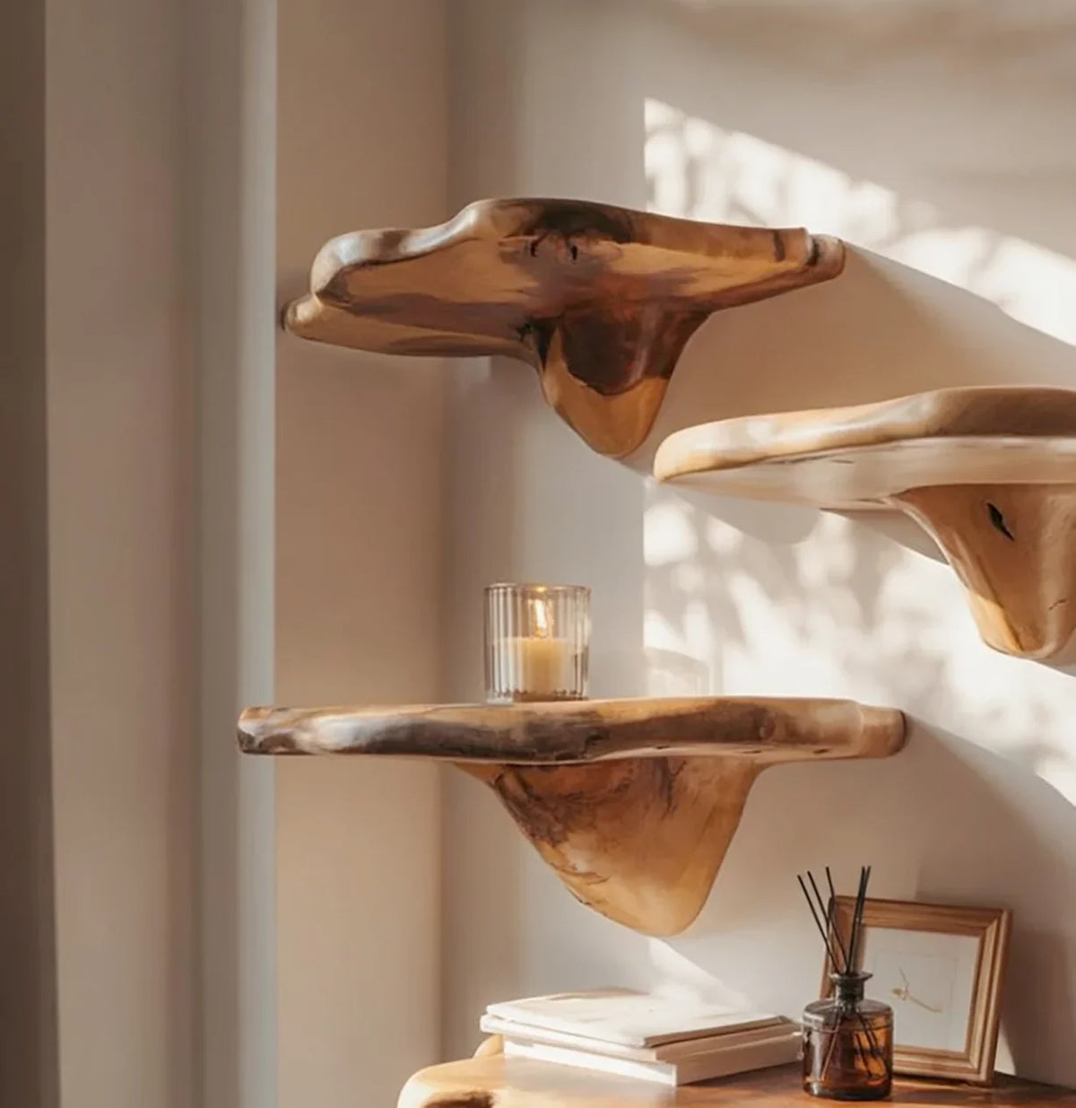 Live edge floating wood shelves on wall, candle and decor in natural light