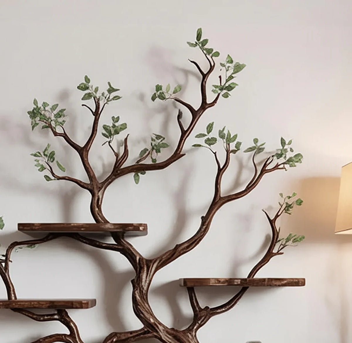 Solid wood tree bookshelf with live edge shelves and branch design against a light wall.