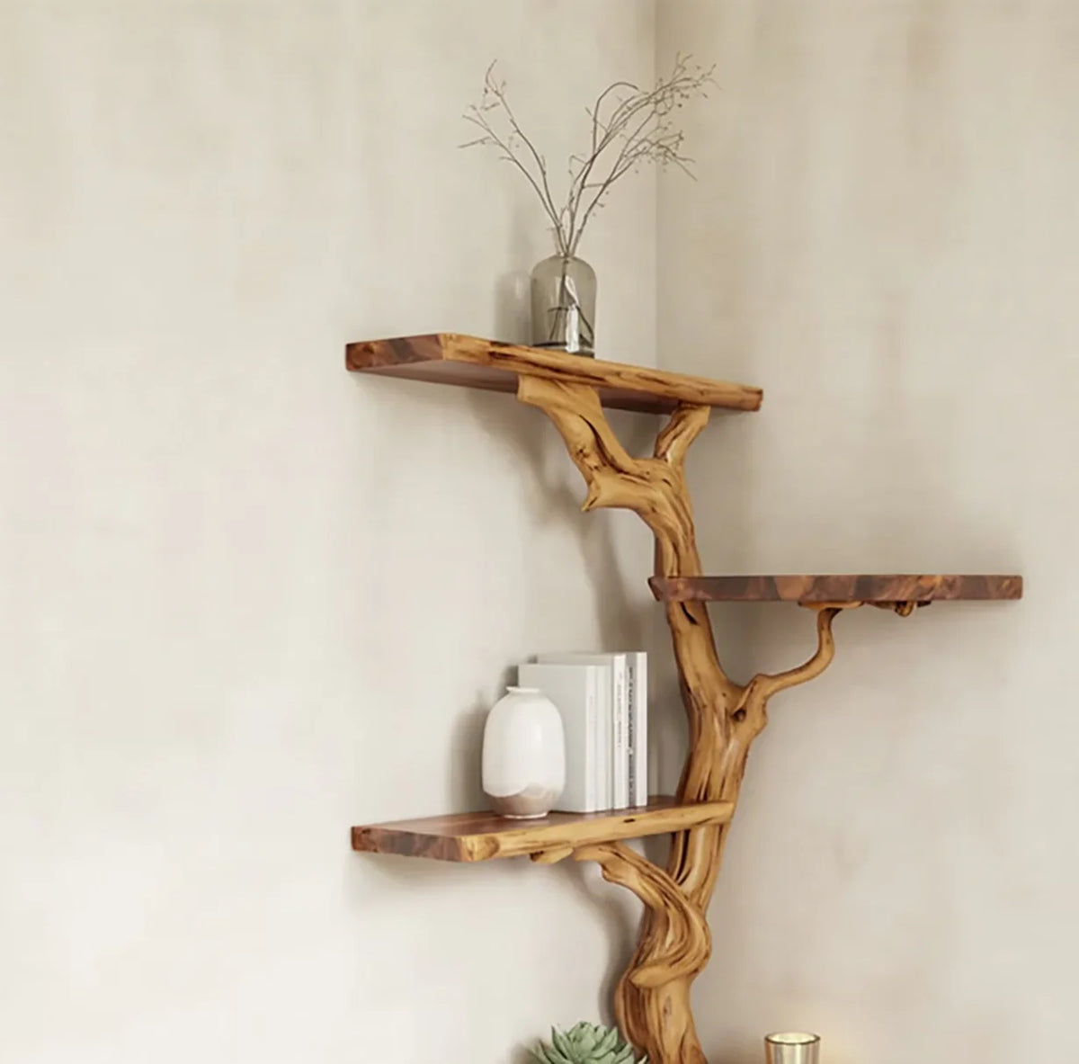 Tree branch-inspired wooden wall shelves with books, vase, dried branches, and decorative items