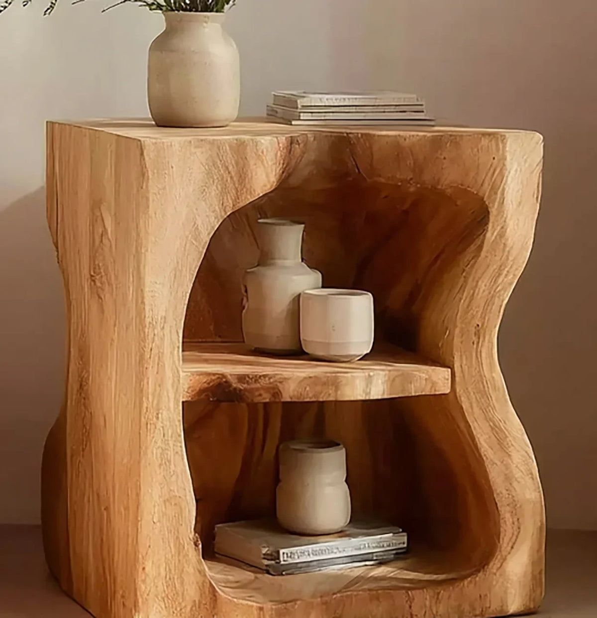 Live edge solid wood side table with shelves, decorative vases, and books.