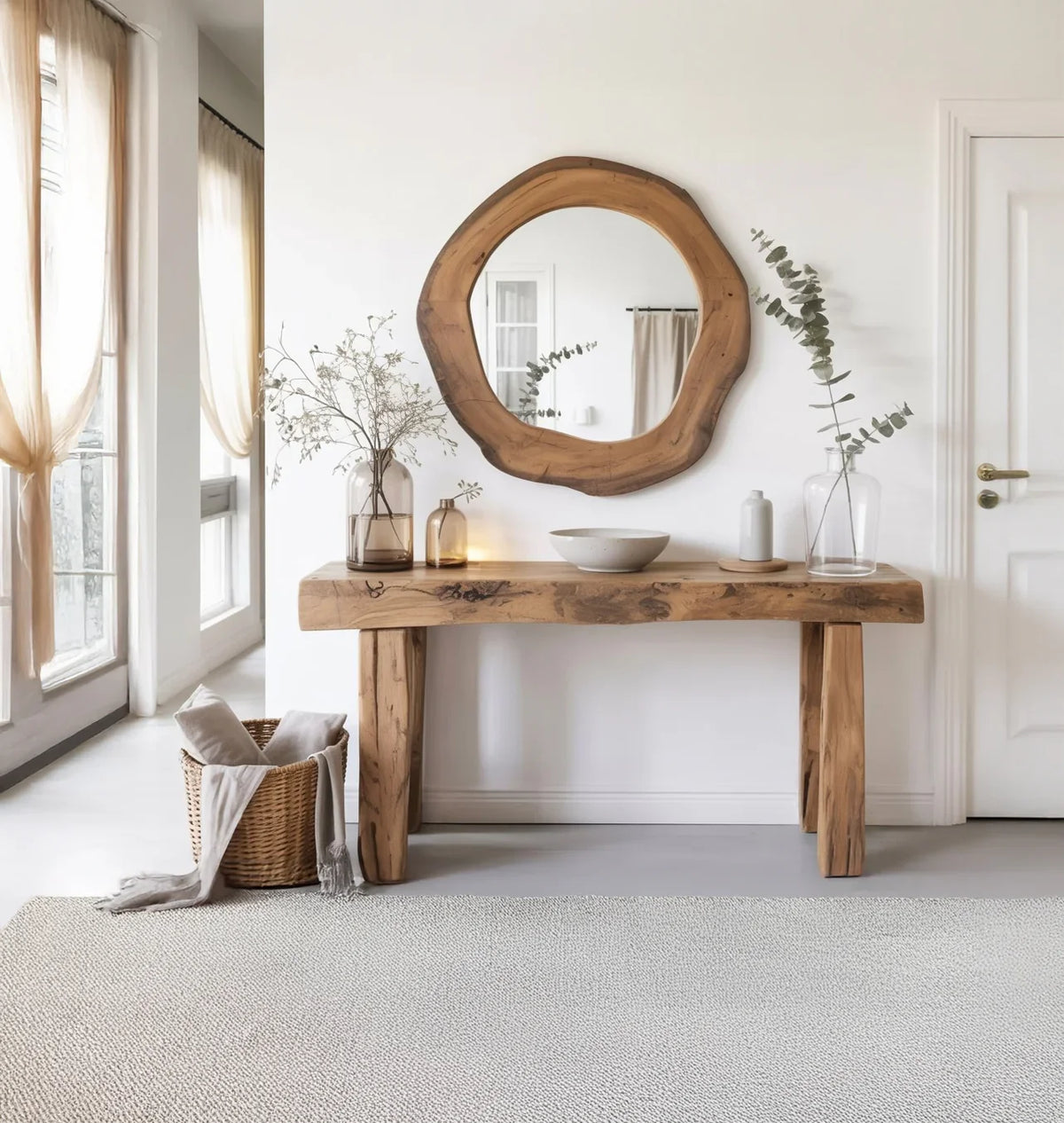 Live edge wood console table and round mirror in bright entryway with minimalist decor