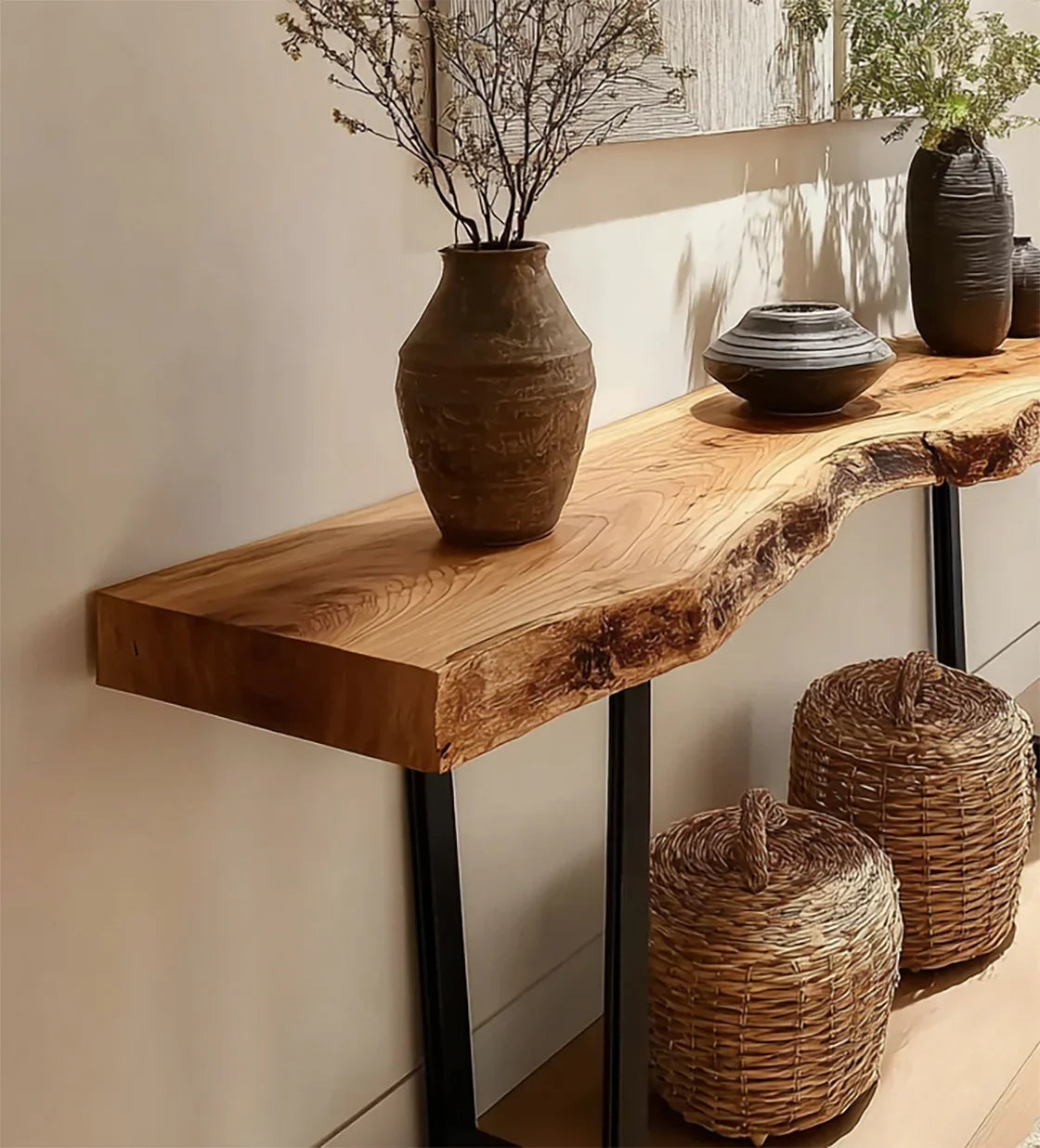 Live edge solid wood console table with metal legs, decorated with ceramic vases and woven baskets