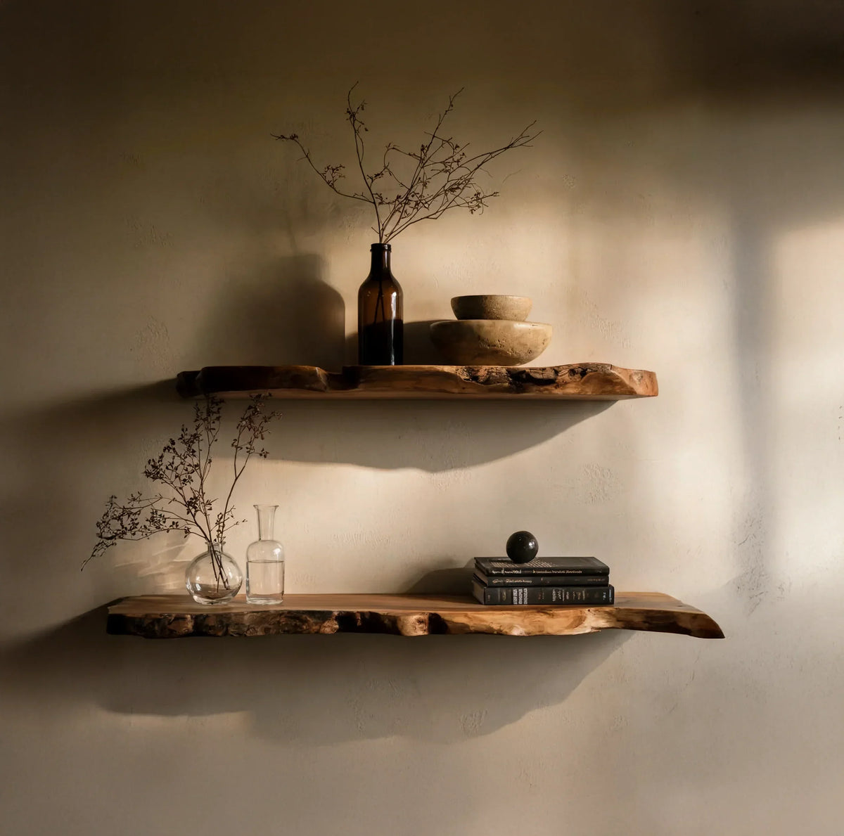 Live edge floating wooden shelves with minimalist decor against a beige wall