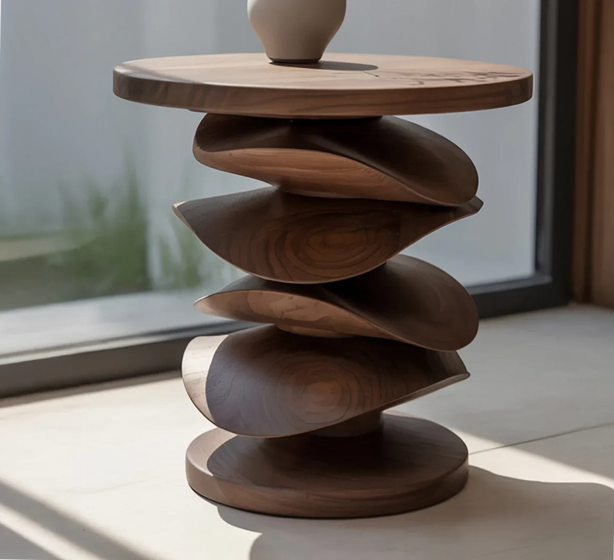 Modern wooden side table with sculptural twisted layers and round top in natural light
