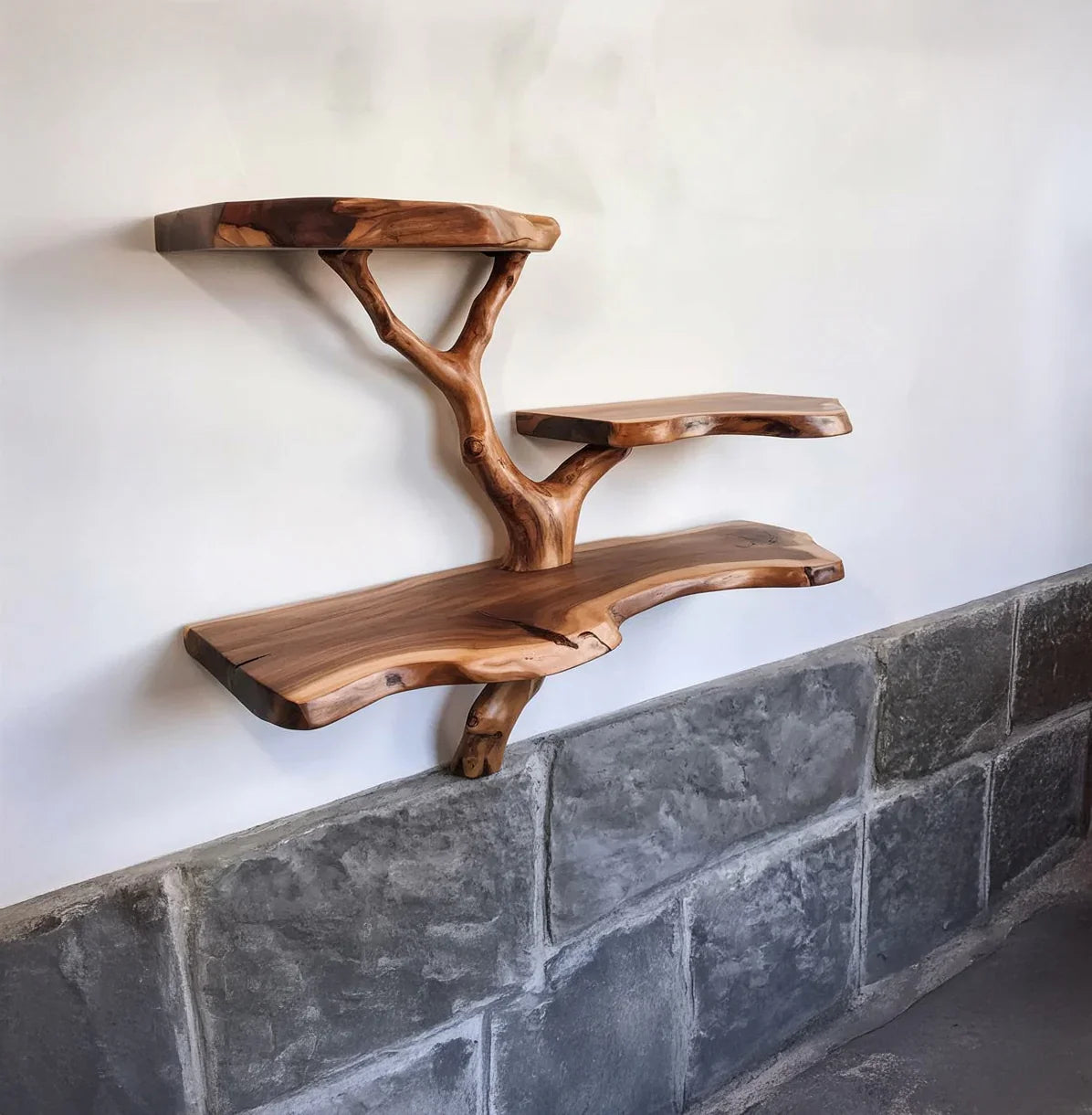 Live edge solid wood tree bookshelf with floating shelves on a white wall