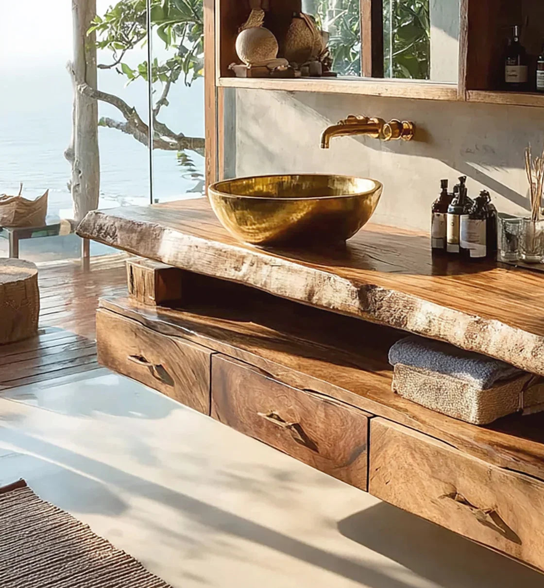 Rustic wooden bathroom vanity with golden vessel sink and brass faucet overlooking ocean view