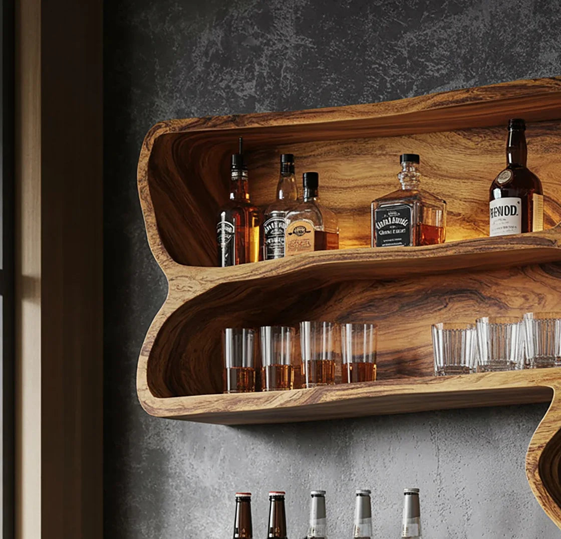 Wooden wall-mounted bar shelf with whiskey bottles and glasses against a textured gray wall