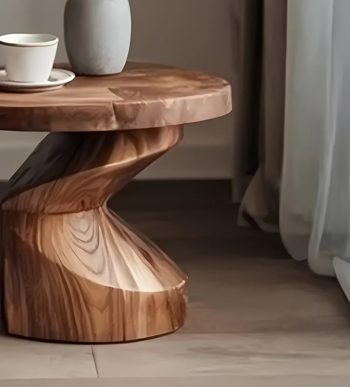 Twisted natural wood side table with a white ceramic cup and vase on top in a minimalist room