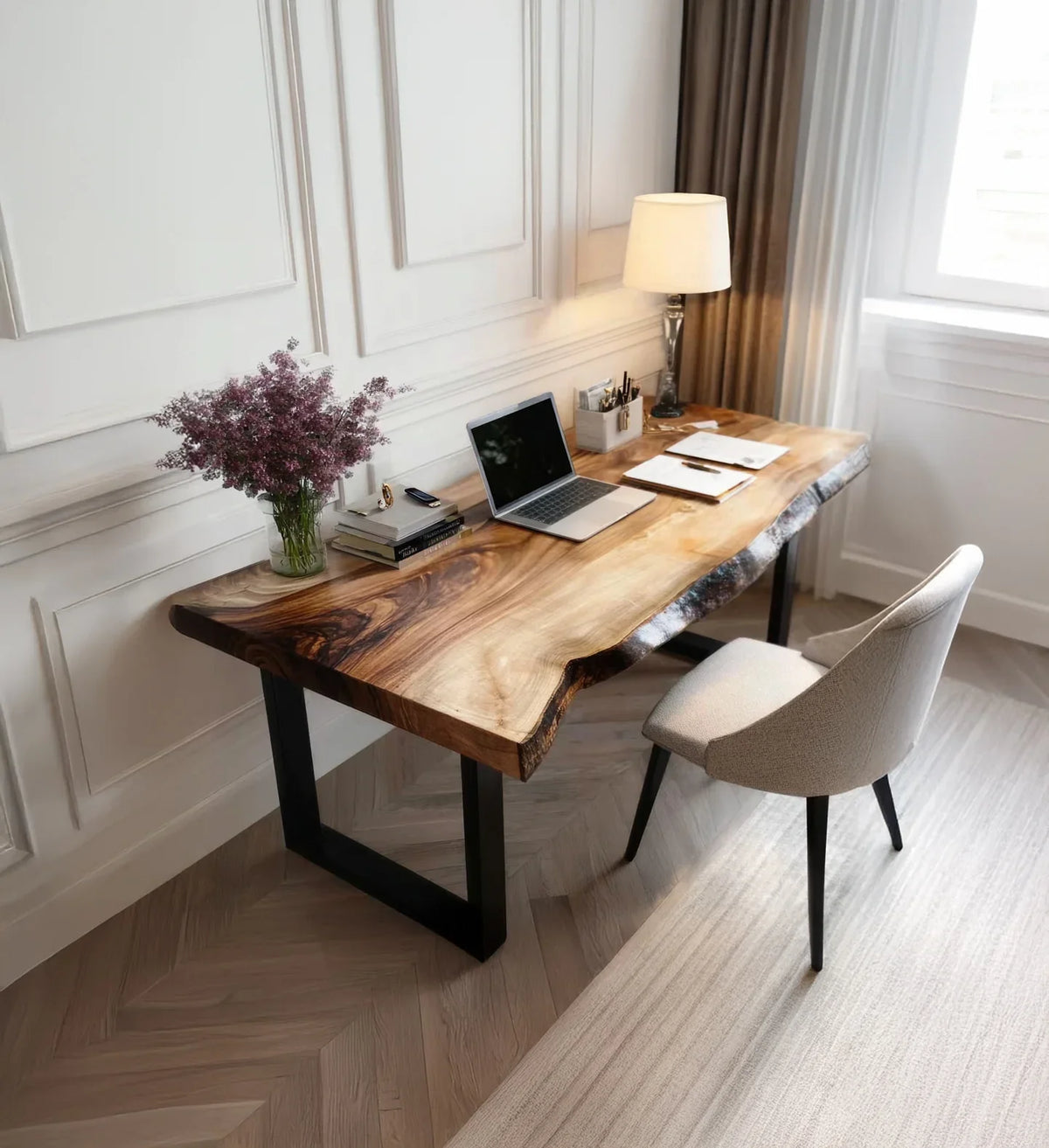 Live edge solid wood desk in modern home office with lamp, laptop, chair, and books