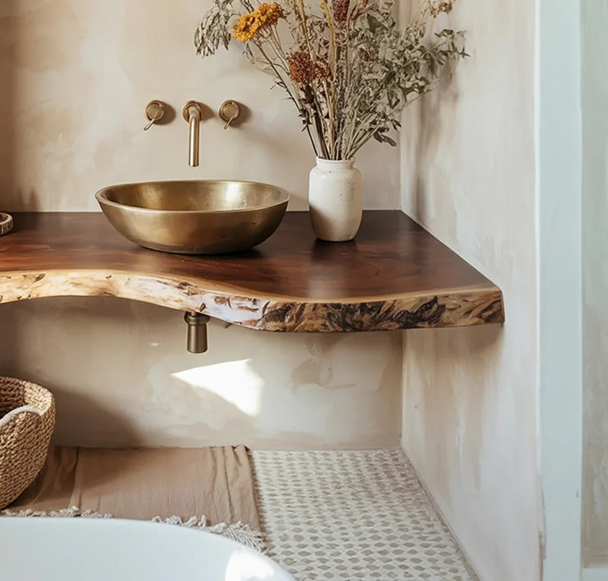 Live edge solid wood floating vanity with brass sink and dried flowers in a minimalist bathroom