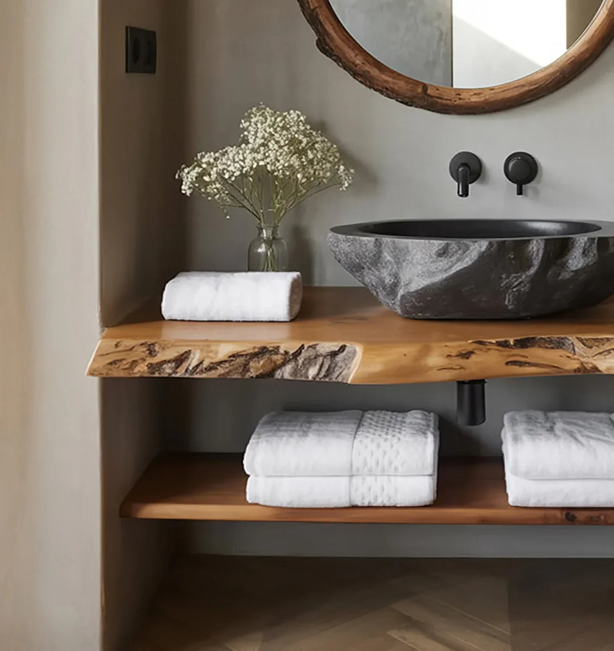 Sustainably crafted live edge wood bathroom vanity with stone sink, towels, and flowers