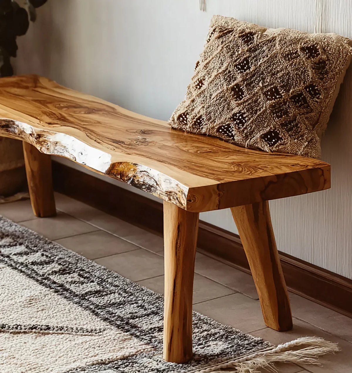 Live edge solid wood bench with natural finish, textured pillow, and cozy rug in a modern room