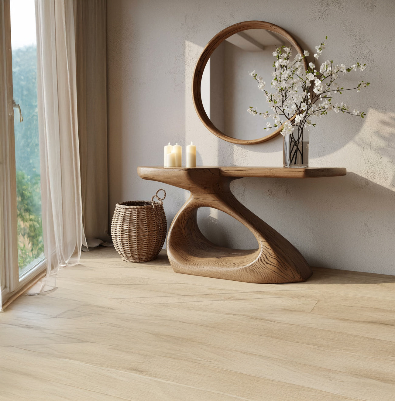 Modern wooden console table with round mirror, white flowers in glass vase, candles, and wicker basket near window