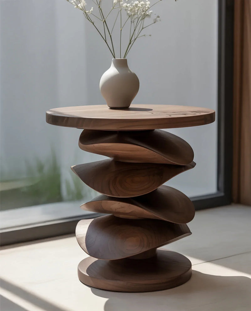 Modern wooden side table with layered curved design and white vase with delicate flowers