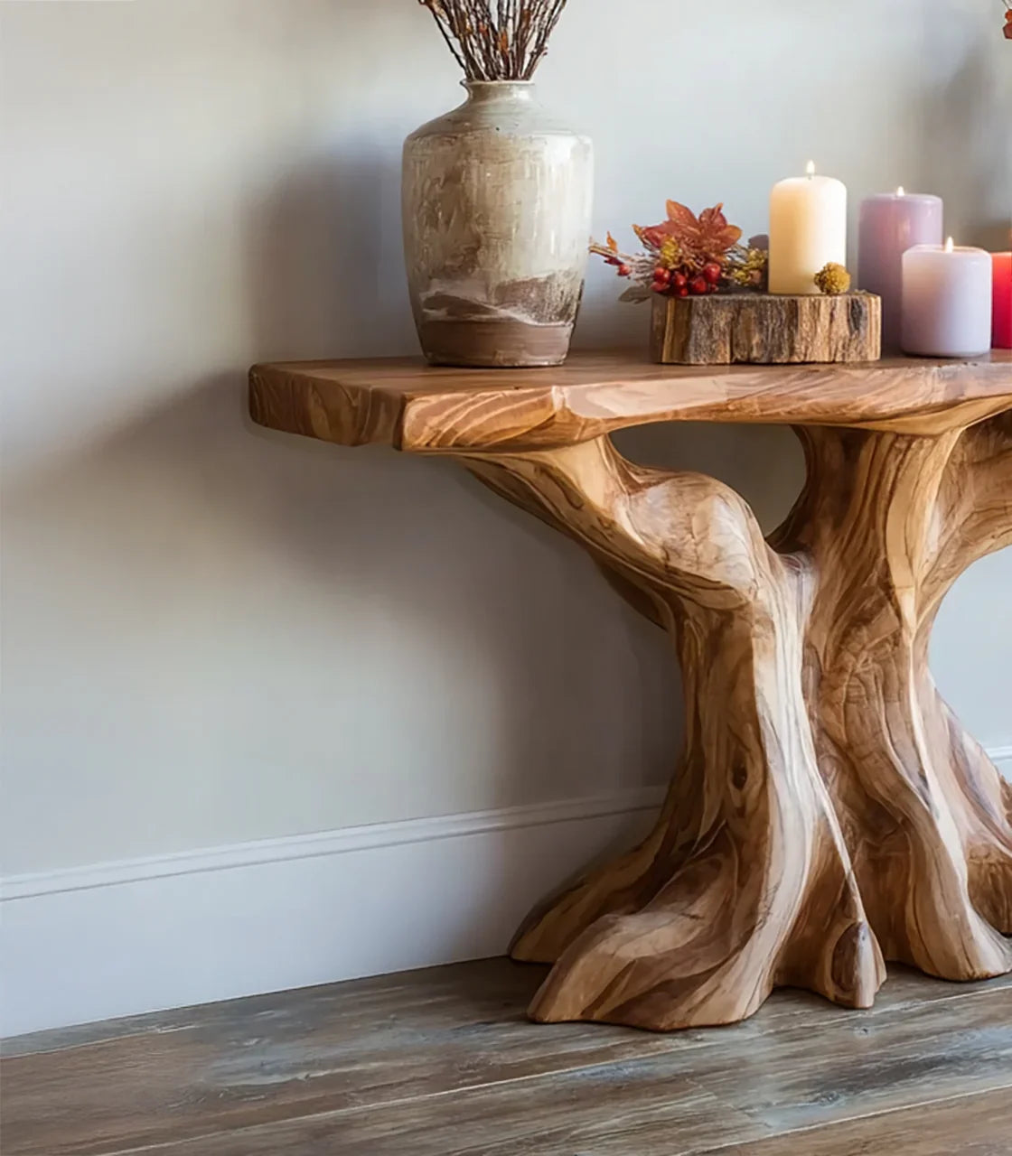 Rustic wooden console table with natural tree trunk legs, ceramic vase, candles, and autumn décor