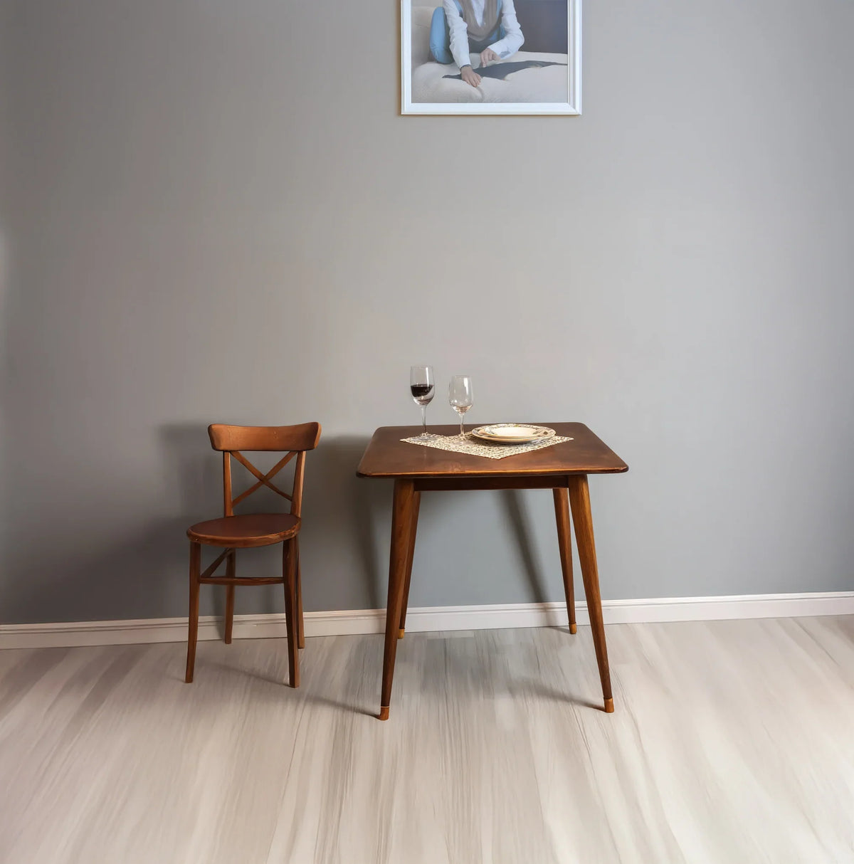 Solid wood dining table and chair set with glasses and plate in minimalist room
