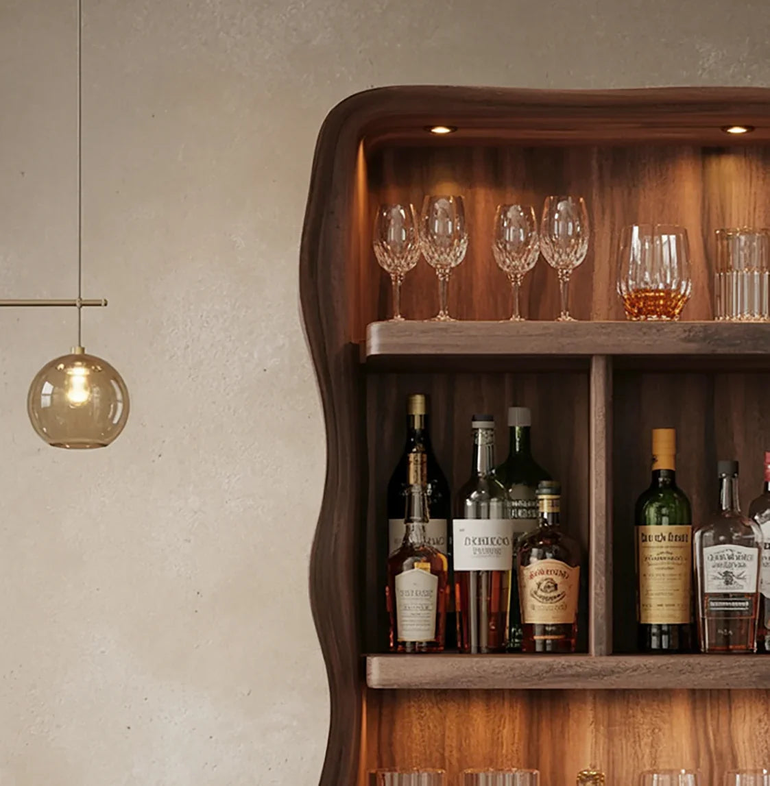 Wooden bar shelf with liquor bottles, crystal wine glasses, and a hanging amber glass pendant light