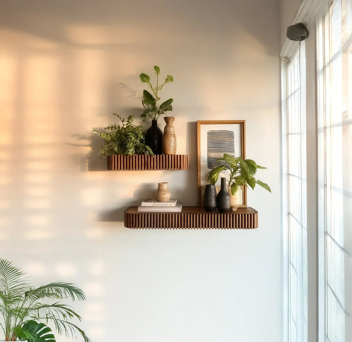 Modern solid wood floating shelves with plants, vases, books, and framed art in sunny room