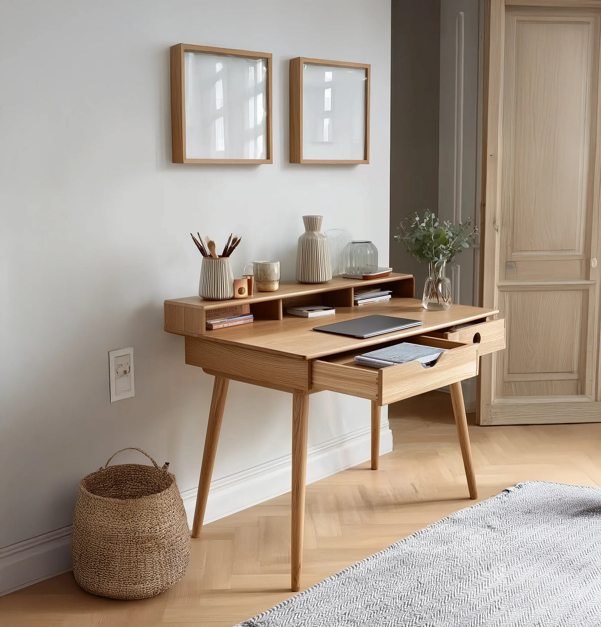Solid wood minimalist desk with open drawer, laptop, decor and books in modern home office