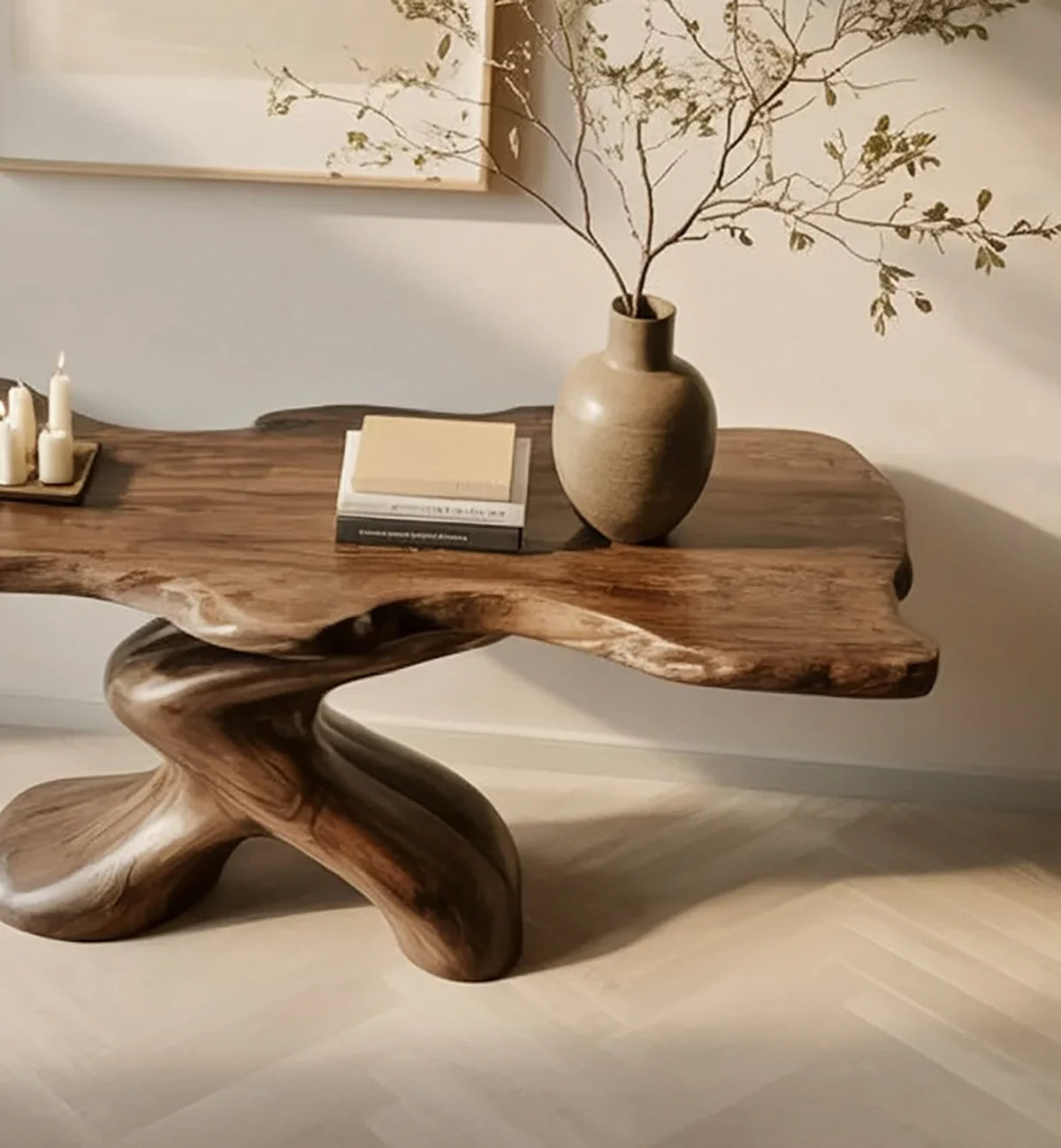 Live edge solid wood table with sculptural base, styled with books, vase, and candles