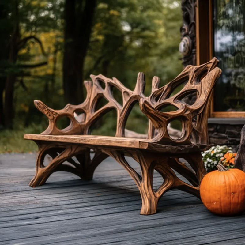Rustic wooden bench with intricate natural design on a porch with pumpkin and flowers