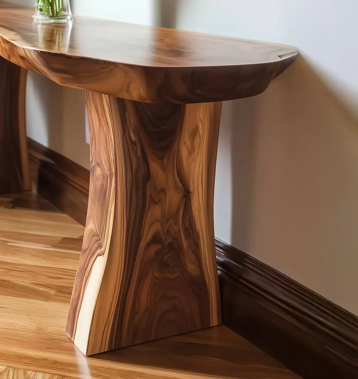 Smooth polished wooden table with natural grain pattern against beige wall and hardwood floor