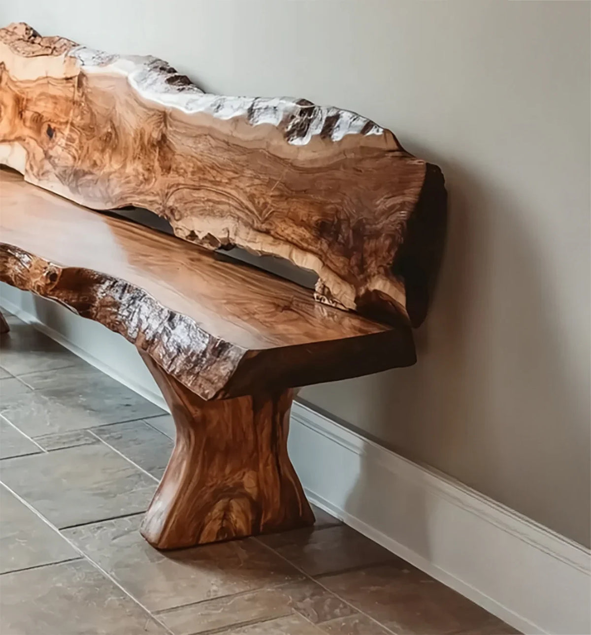 Polished live edge wooden bench with natural grain and unique carved base against beige wall