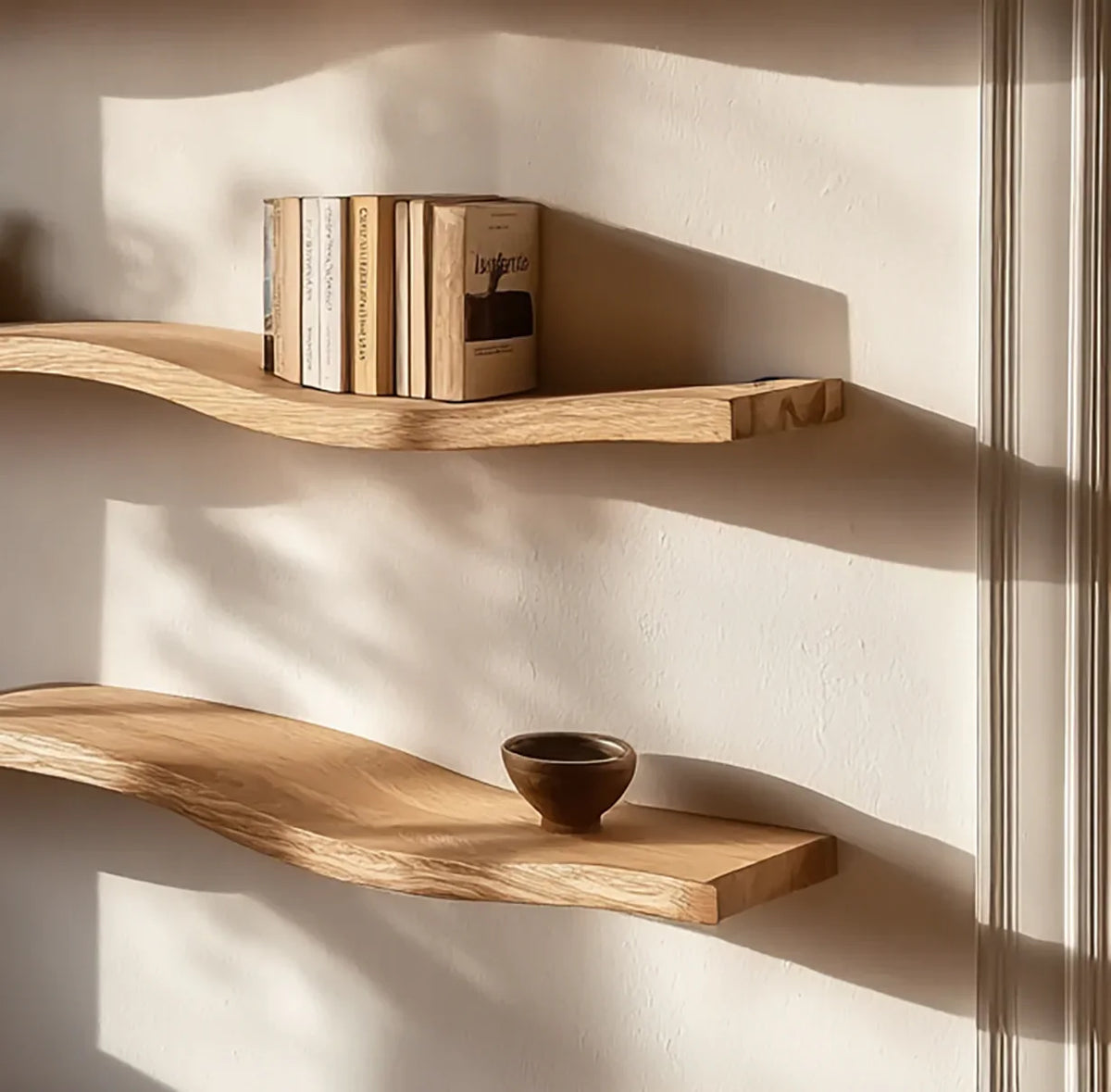 Sustainably crafted live edge floating wood shelves on wall, with books and a small bowl