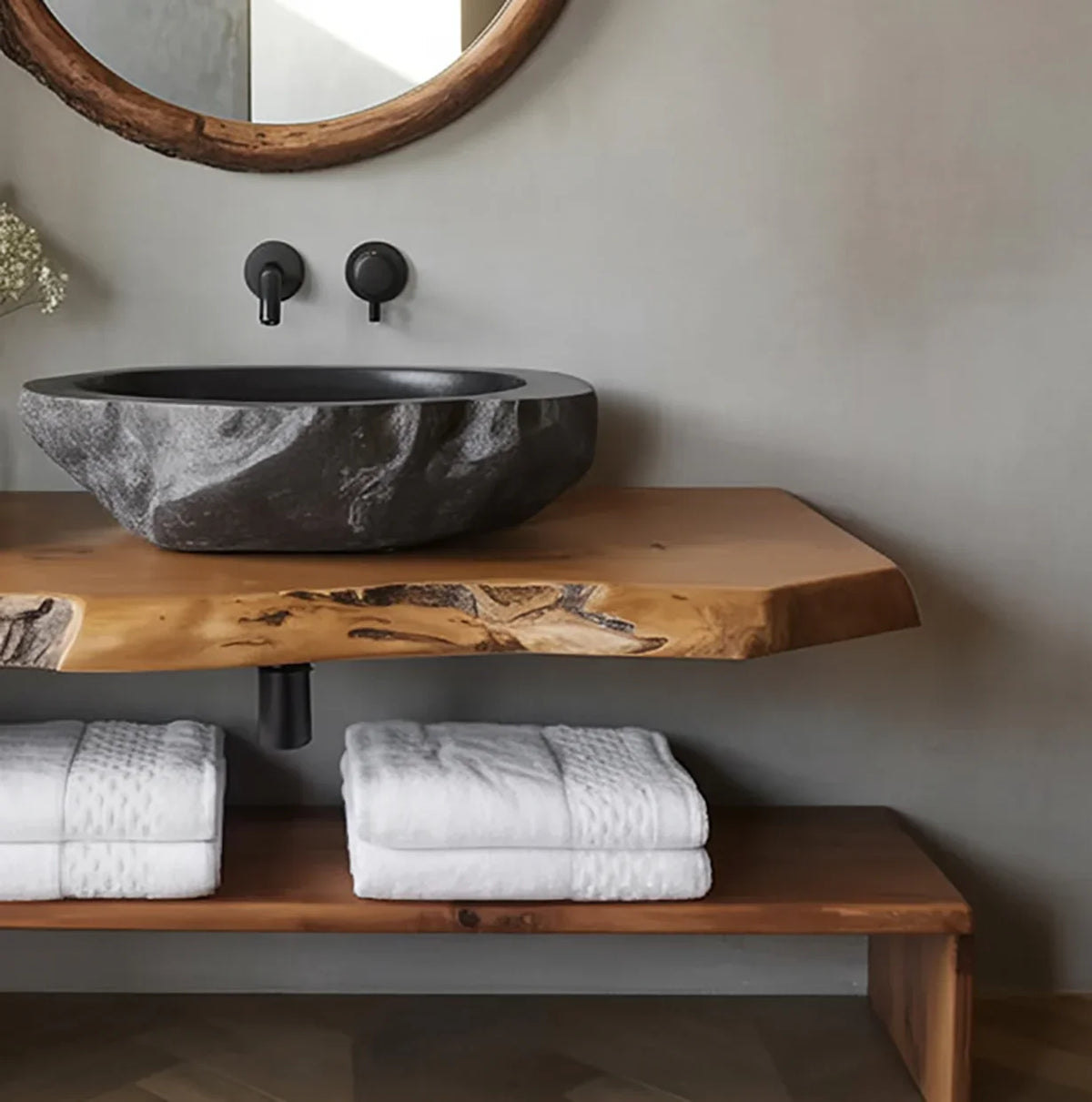 Live edge wood vanity with stone vessel sink and stacked white towels, modern bathroom decor