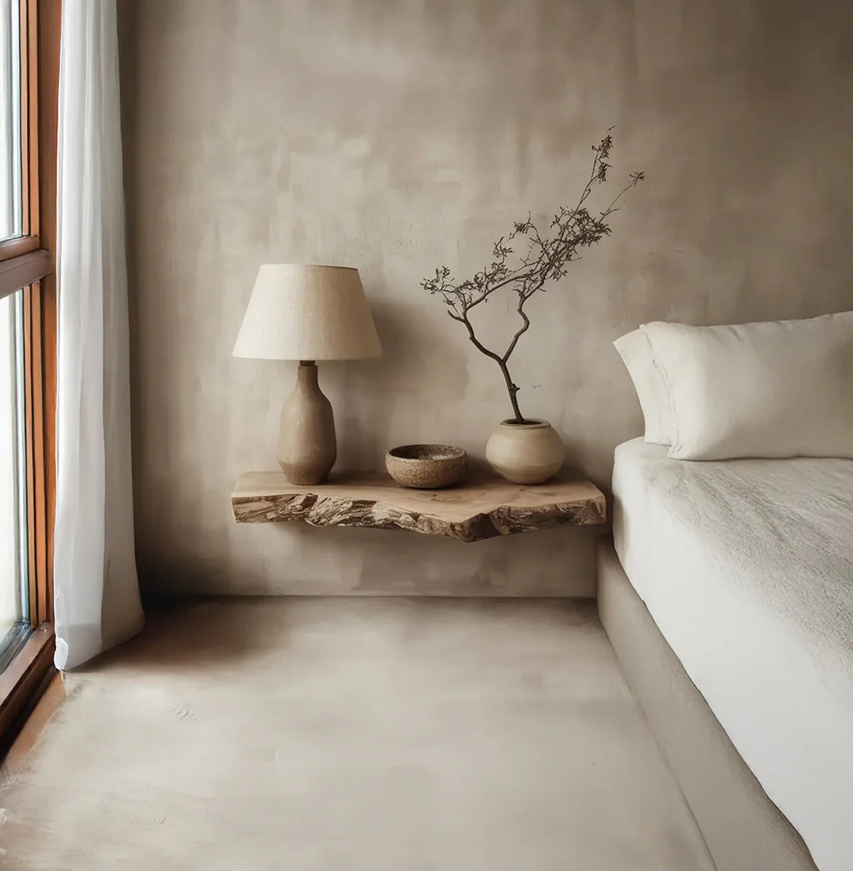 Minimalist bedroom with live edge floating wood shelf, ceramic lamp, and potted plant decor.