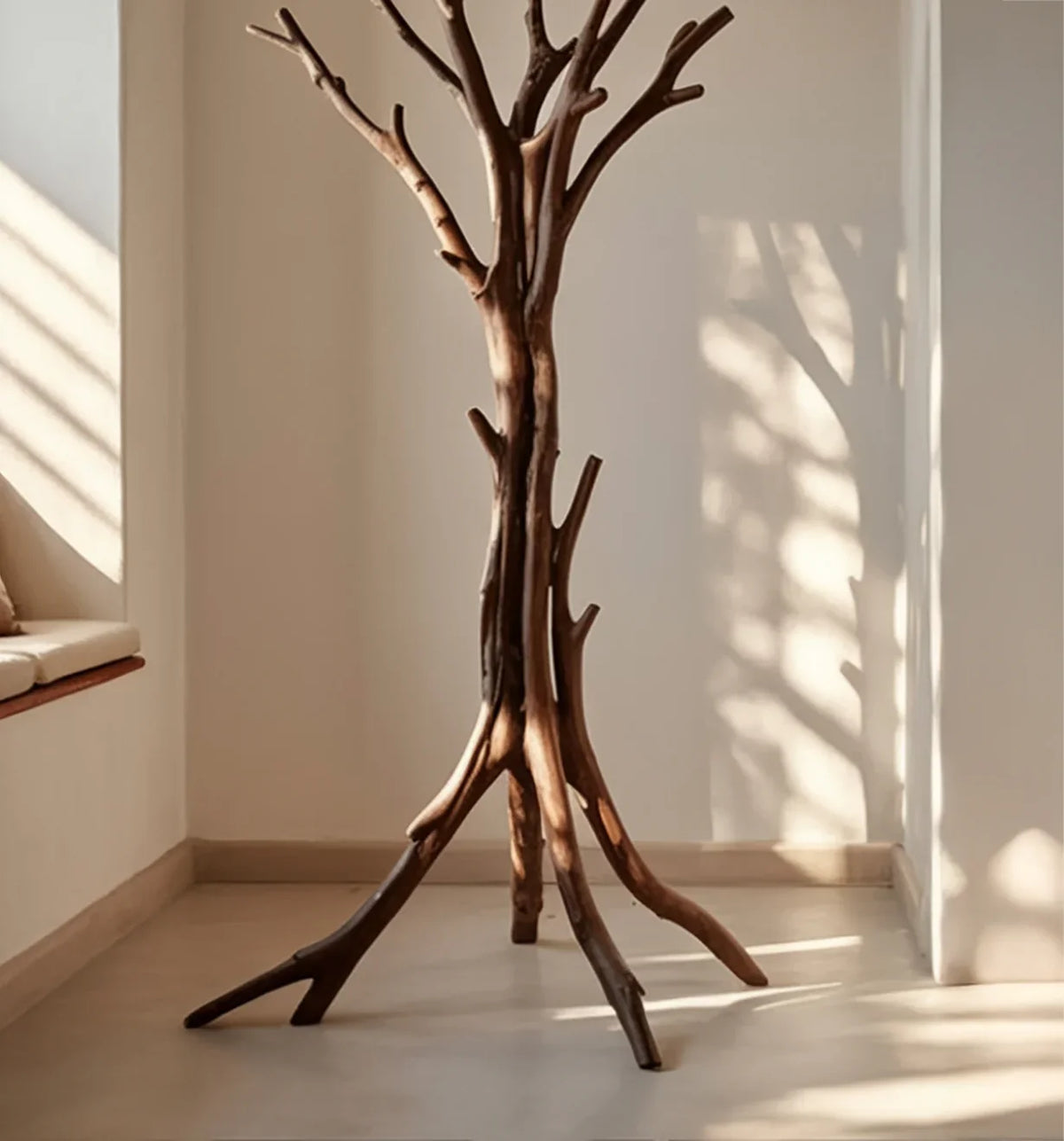 Solid wood tree bookshelf with natural branches in a sunlit minimalist room