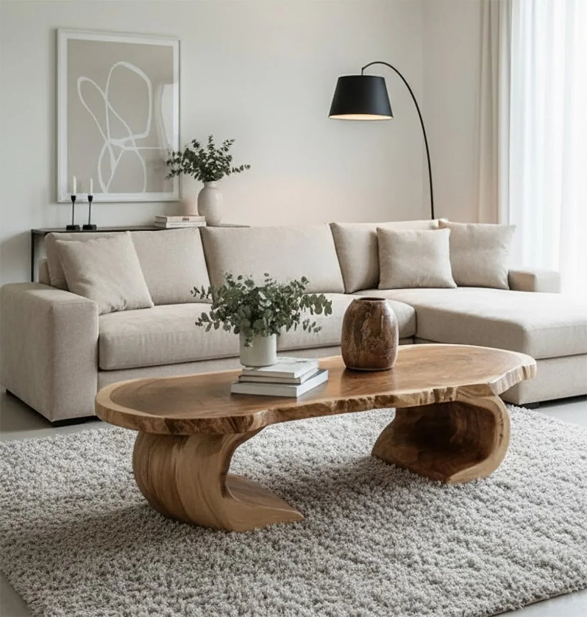 Modern living room with beige sectional sofa, unique wooden coffee table, black floor lamp, and minimalist decor