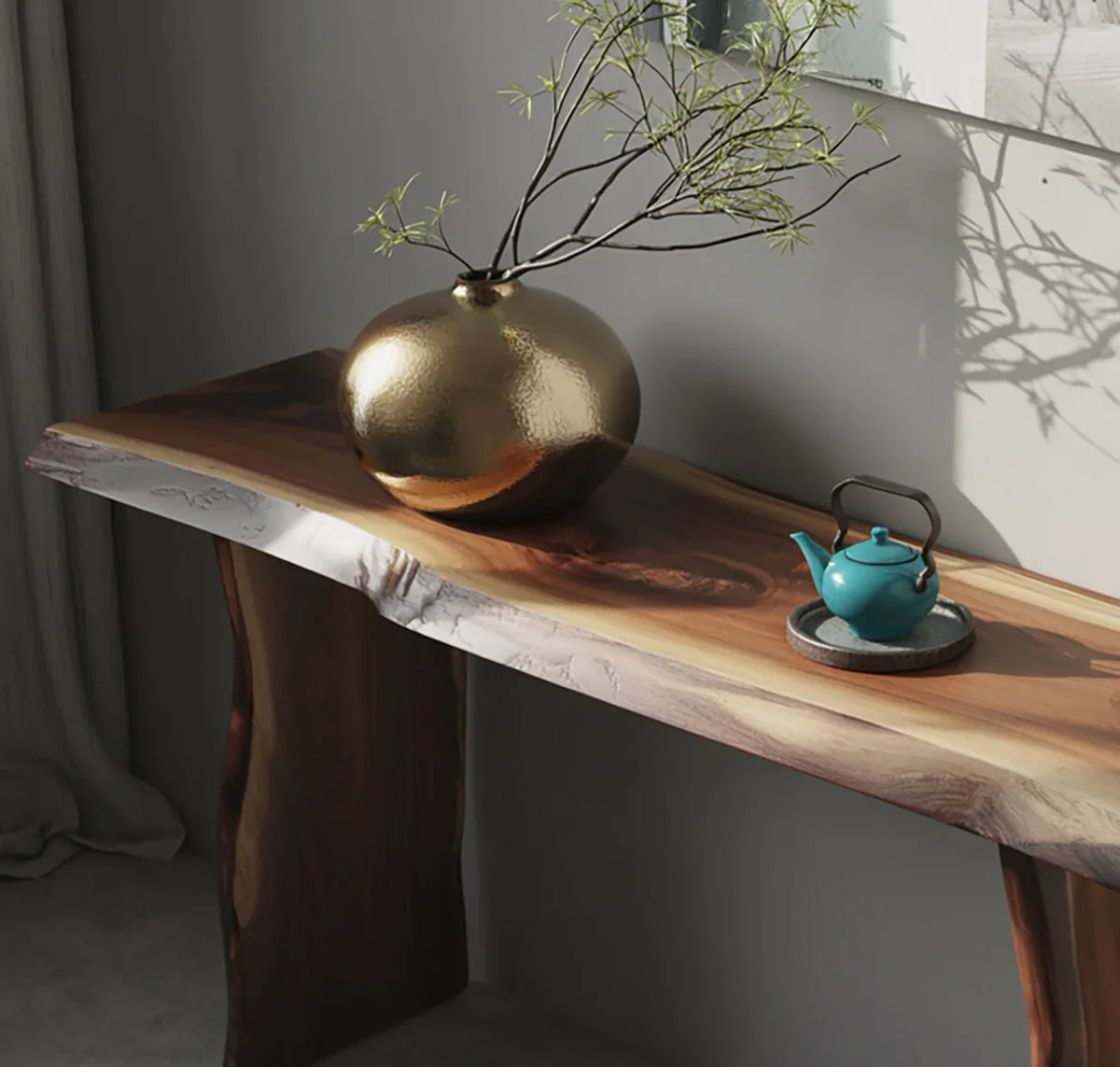 Live edge solid wood console table with gold vase and small teal teapot in modern room