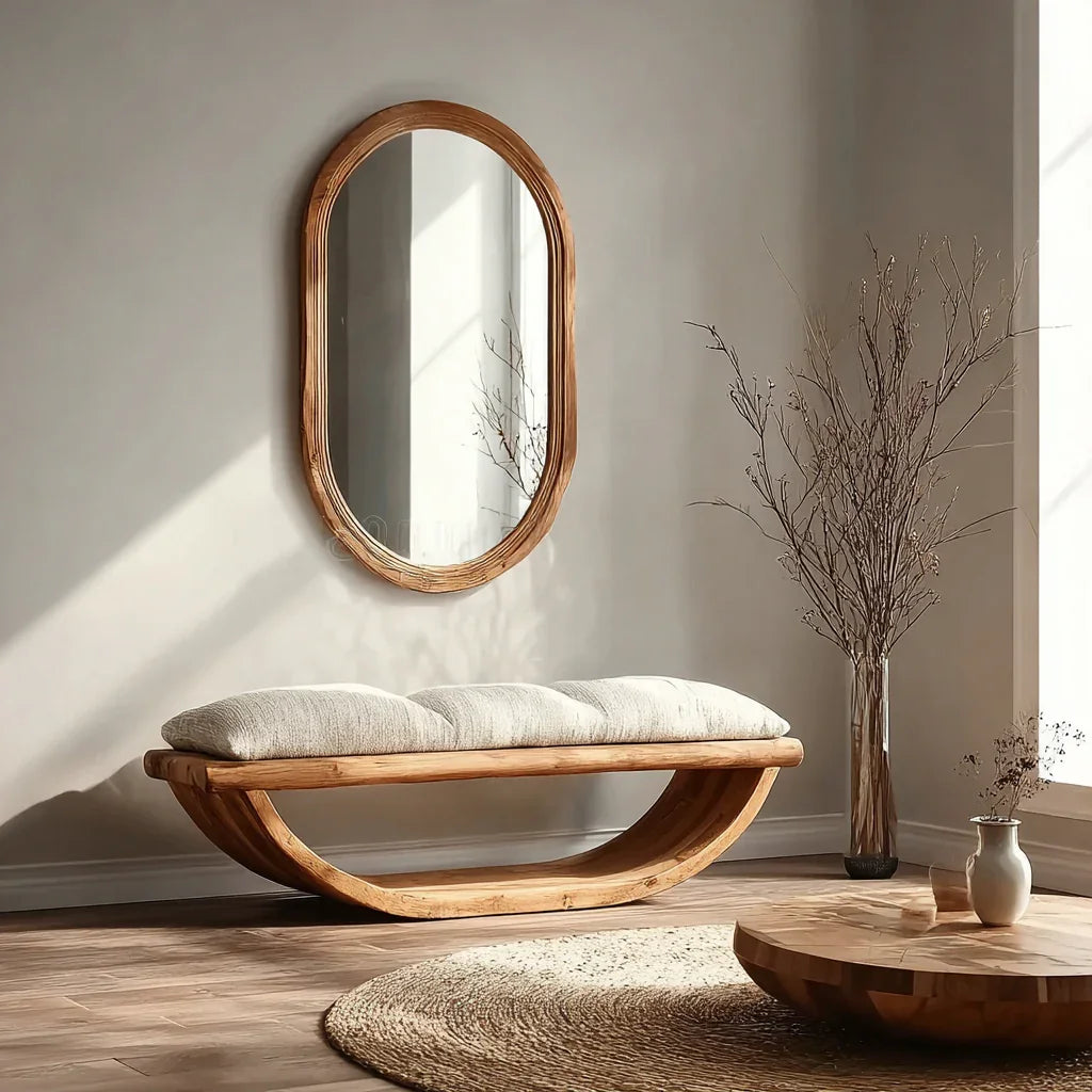 Modern entryway with live edge wood bench, oval cushion, oval mirror, and round wood table