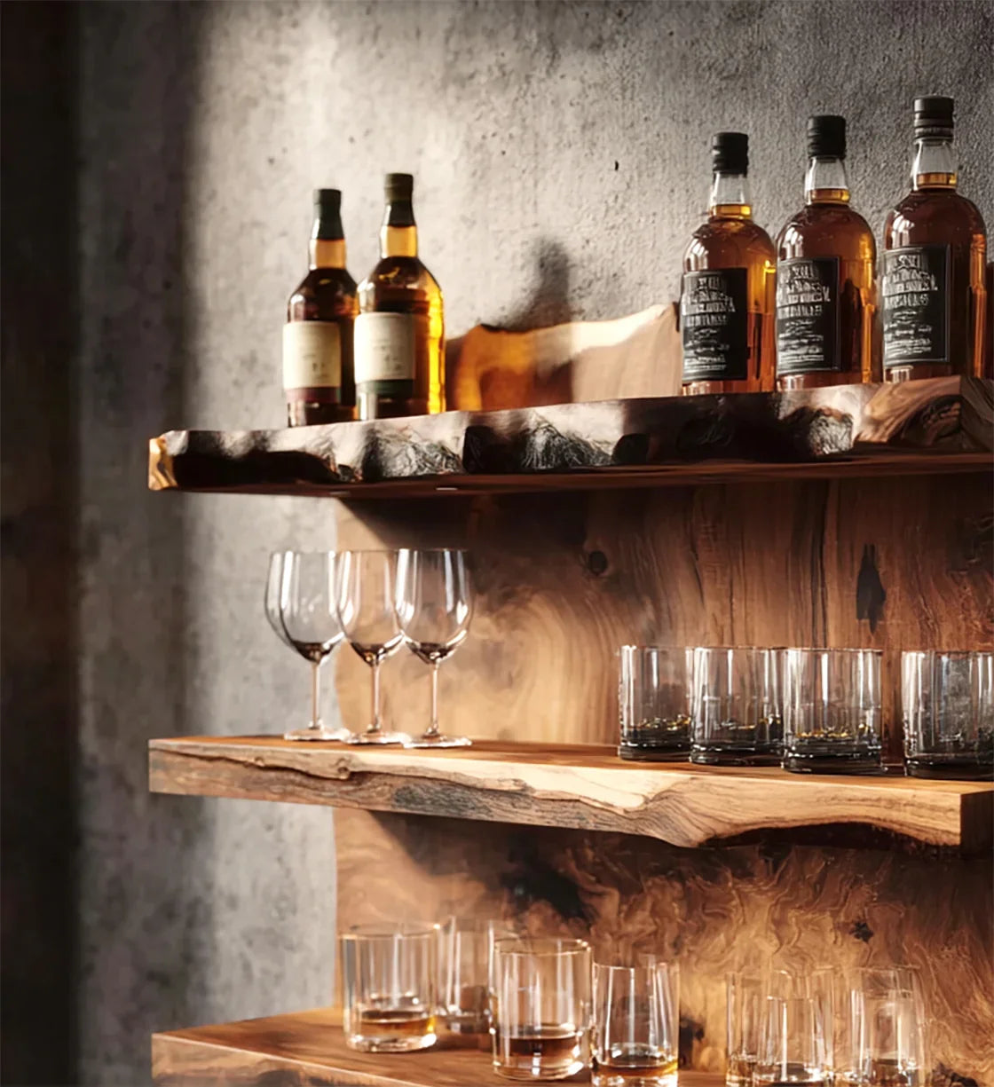Whiskey bottles and glasses on rustic live edge wooden shelves with textured concrete wall background