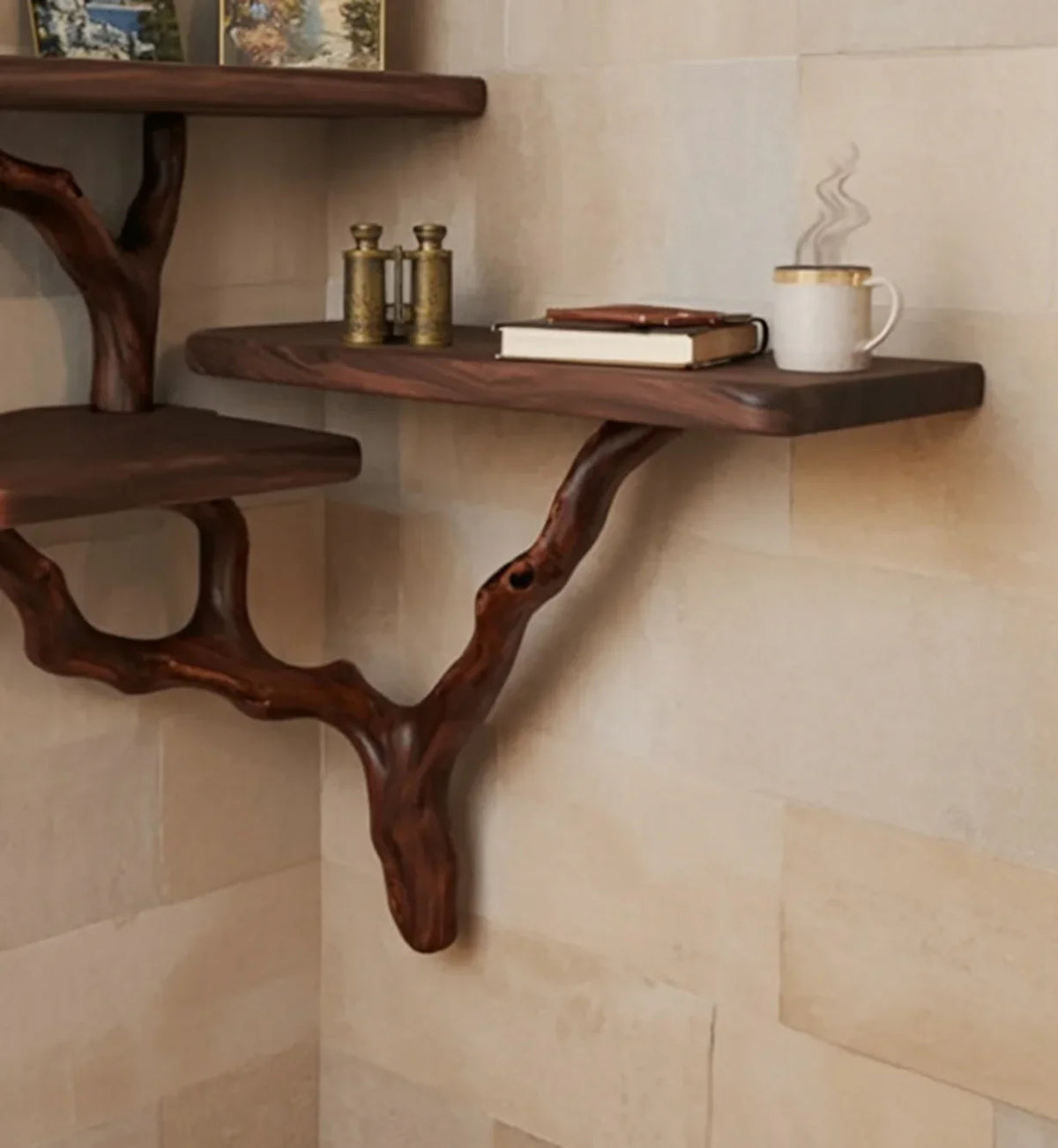 Live edge solid wood floating shelf with branch-style supports, books, and a coffee mug