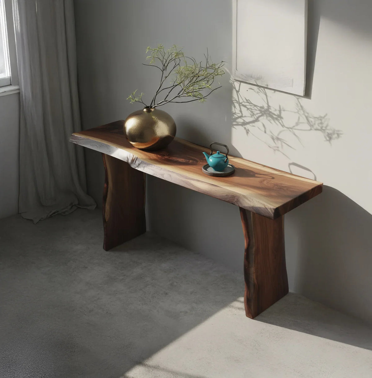 Live edge solid wood console table in minimalist room with gold vase and teal teapot