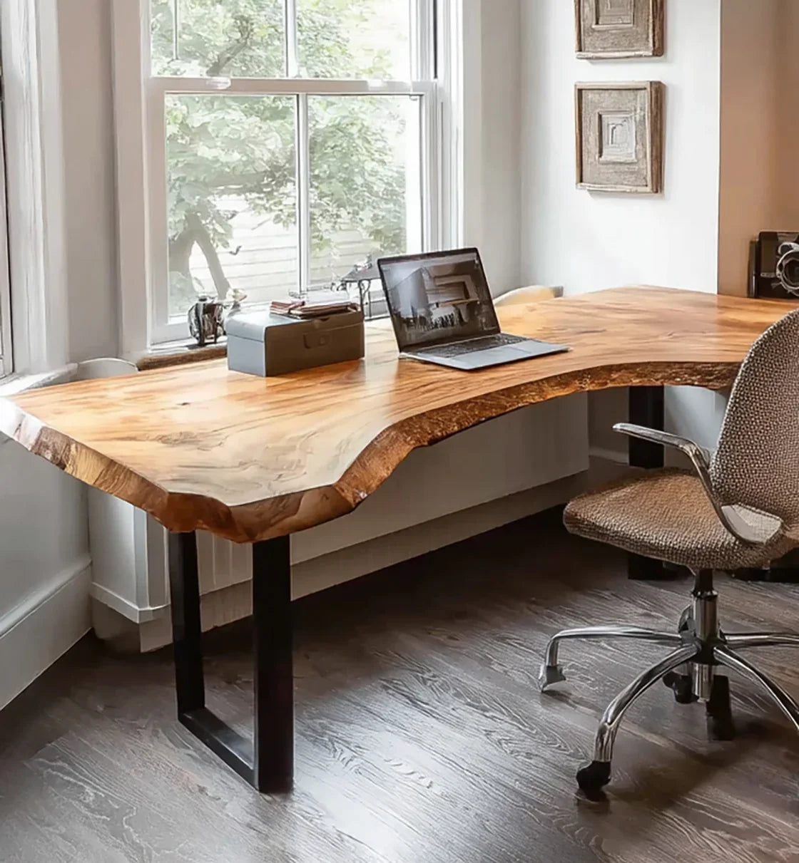 Live edge wooden desk in home office with laptop, natural light and modern decor