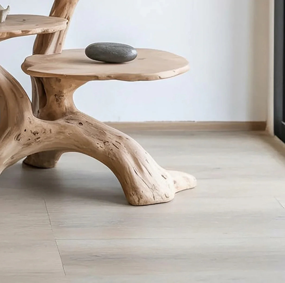 Live edge solid wood table with natural tree branch design in a minimalist room