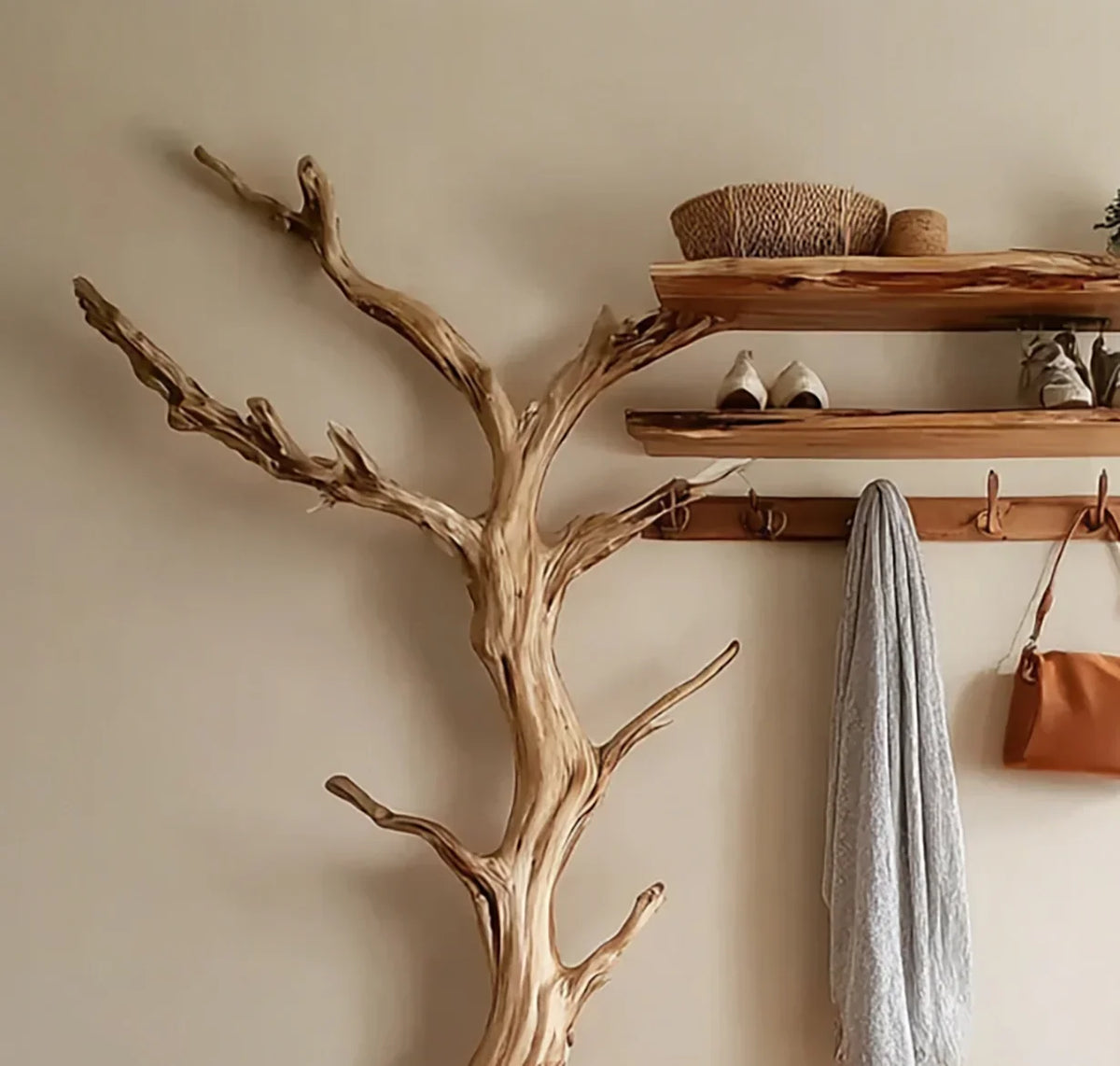 Live edge tree bookshelf with solid wood floating shelves and wall hooks in a modern entryway