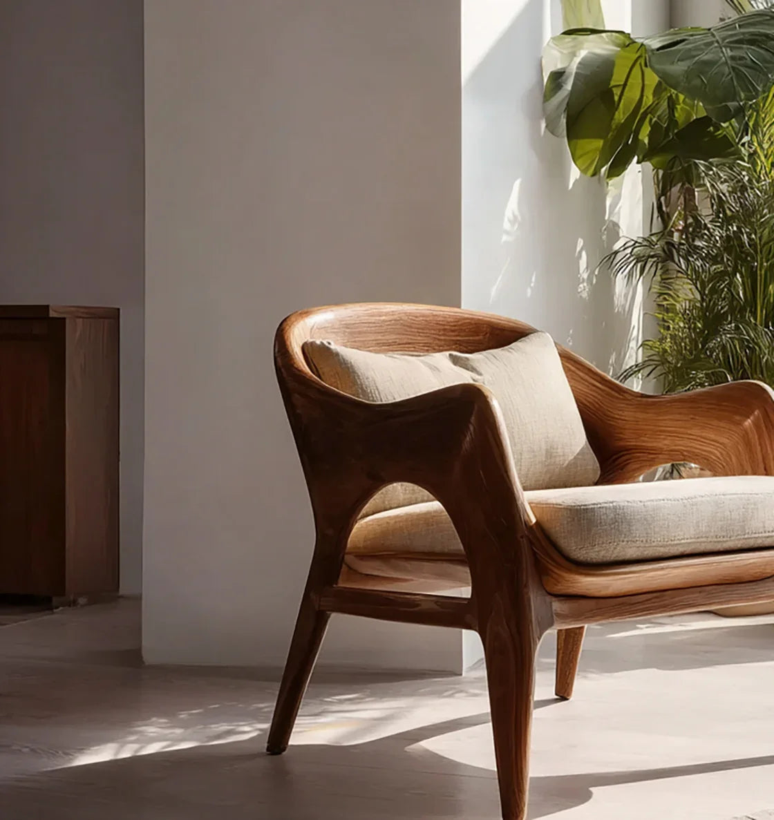 Solid wood armchair with beige cushions in sunlit modern living room, indoor plants nearby
