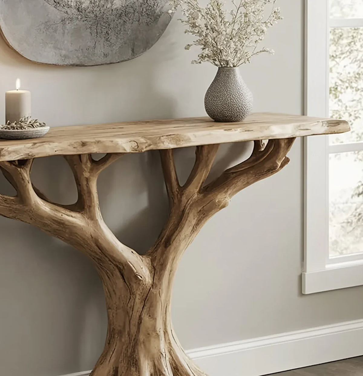 Live edge wood console table with tree branch base, candle, and vase in modern room