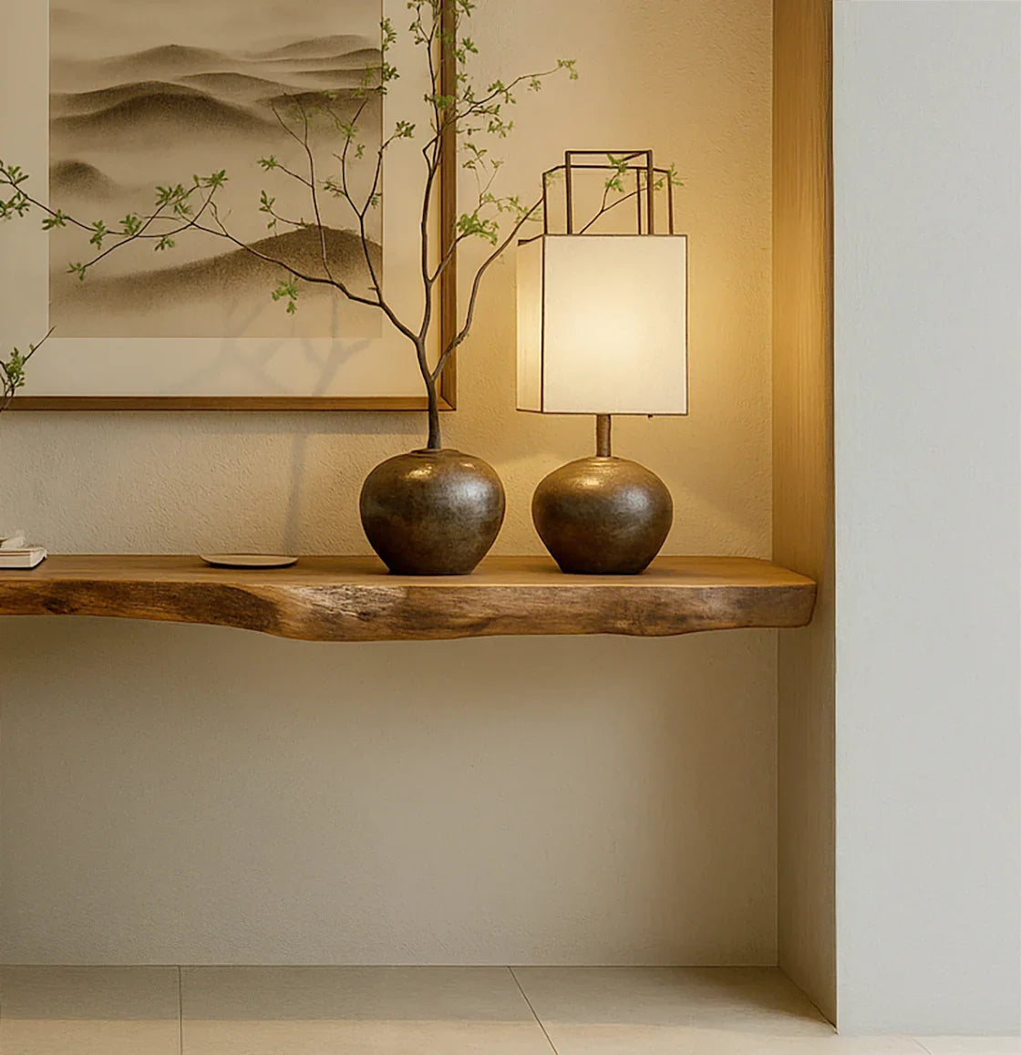 Minimalist wooden shelf with bronze vase holding a branch and matching lamp in cozy interior