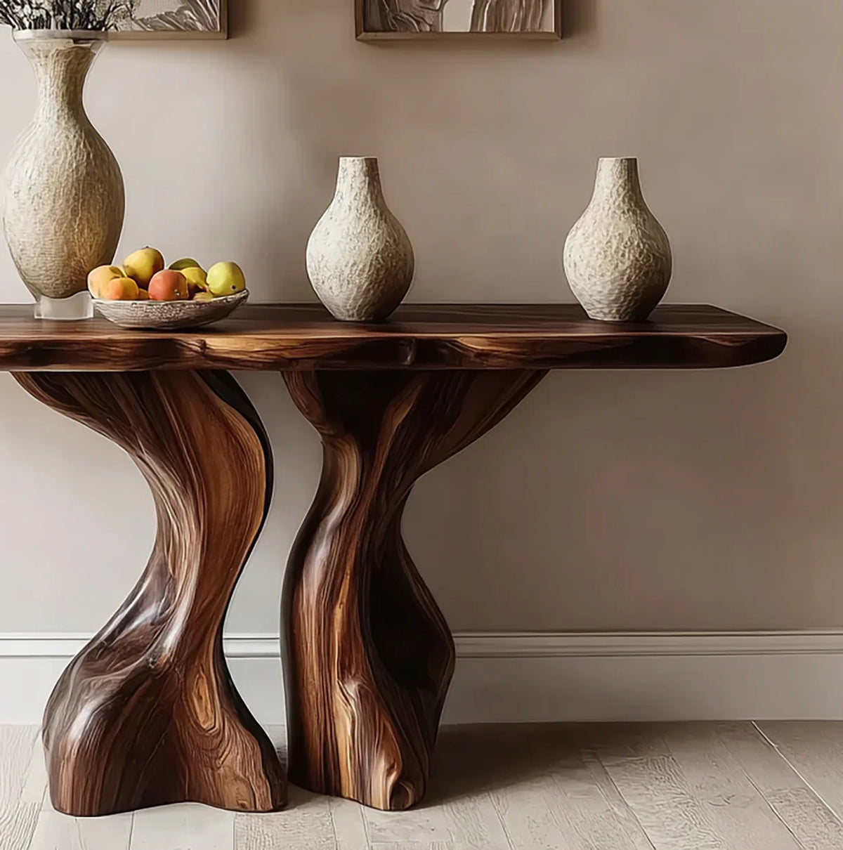 Organic wooden console table with three textured ceramic vases and a fruit bowl against beige wall