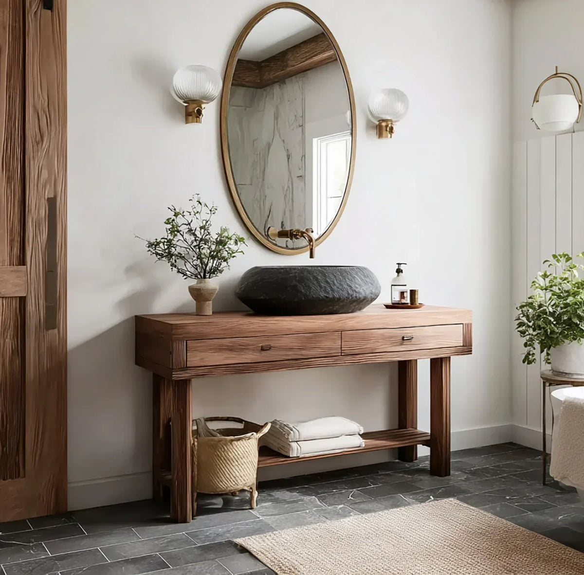 Solid wood bathroom vanity with stone sink, oval mirror, and modern decor in natural light