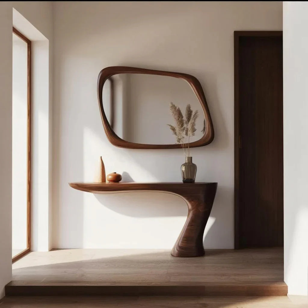 Modern hallway with sculptural wooden console table and organic-shaped wooden framed mirror